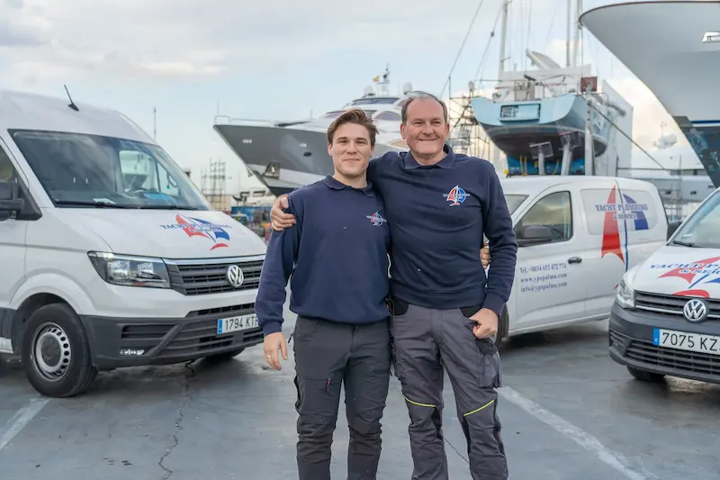 Equipo familiar de Yacht Plumbing Mallorca junto a vehículos de servicio en Mallorca